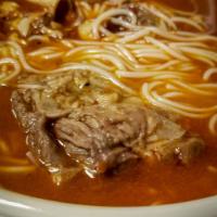 Spicy Beef Soup · Wok tossed beef in our housemade garlic chili sauce served with rice noodles.