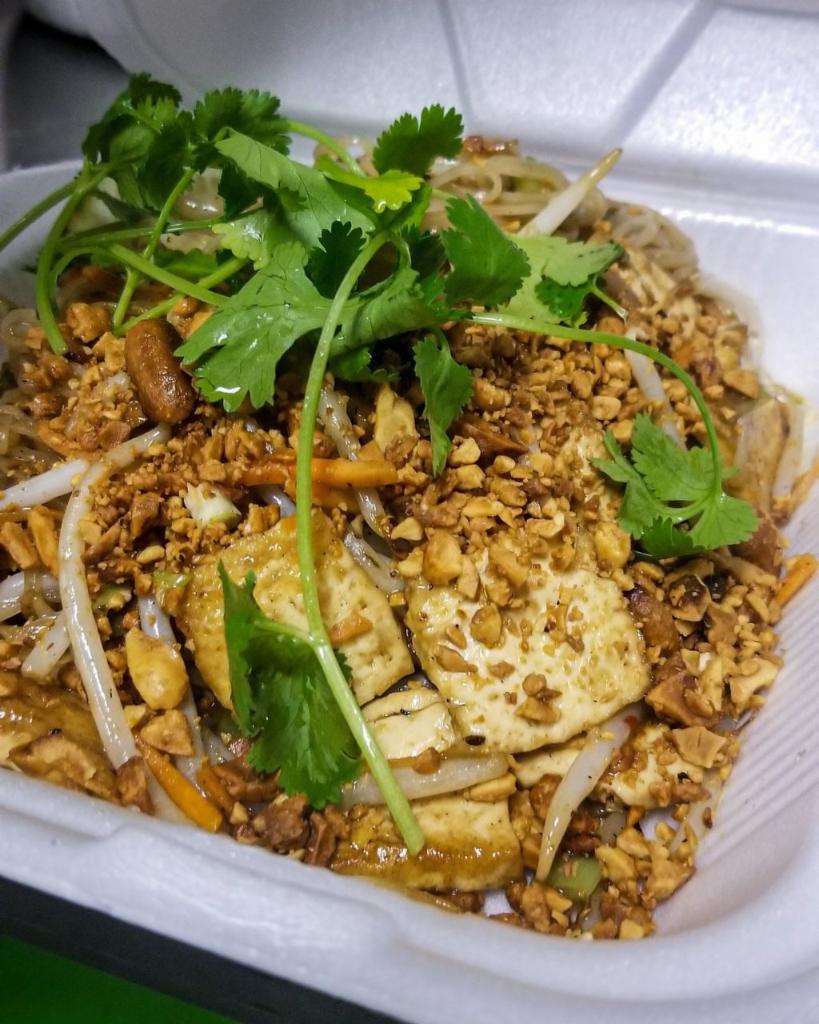 Tofu Pad Thai Noodles · Wok tossed rice noodles in a sweet and tangy tamarind sauce with bean sprouts, carrots and onions. Garnished with crushed peanuts, cilantro and lime