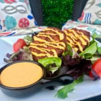 Island Crab Cakes · Pan-seared Creole crab cakes served with a side of house-made Sriracha aioli.