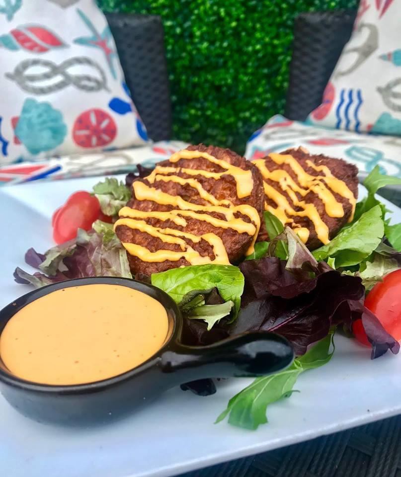Island Crab Cakes · Pan-seared Creole crab cakes served with a side of house-made Sriracha aioli.