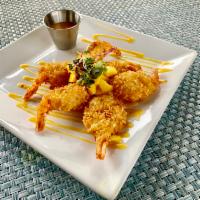 Coconut Mango Shrimp · Shrimp dredge in coconut flakes fried finished with fresh diced mango and coconut flakes ser...