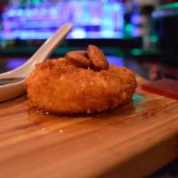 Queijo de Cabra Frito / Fried Goat Cheese · Goat cheese tossed in panko breading, fried & topped with honey & a side of guava paste & al...