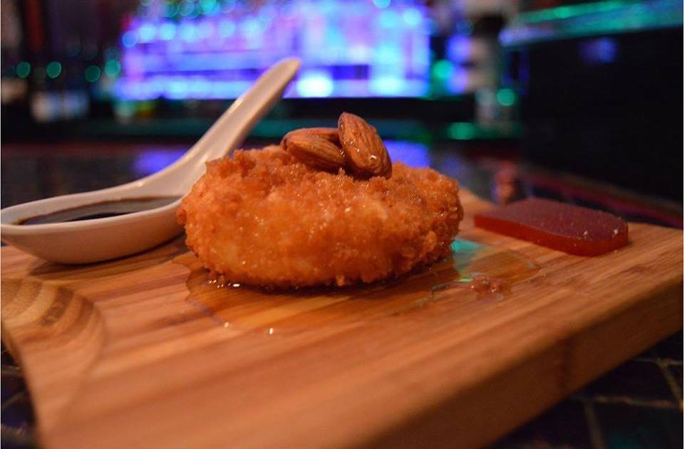 Queijo de Cabra Frito / Fried Goat Cheese · Goat cheese tossed in panko breading, fried & topped with honey & a side of guava paste & almonds