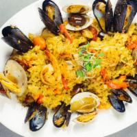 Island Style Paella · A seafood feast of shrimp, sea scallops, calamari, tuna, littlenecks, mussels and chorizo in...
