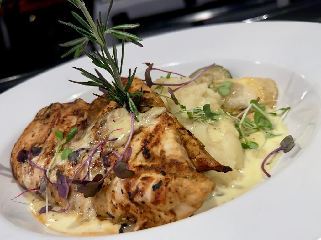 Rosemary Chicken · Chicken breast, pan seared to perfection over mashed potatoes topped with rosemary creamy sauce & side of vegetable