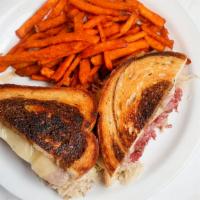 Fuzzy’s Famous Rueben Sandwich · Thin sliced corned beef brisket piled high on top of grilled marble rye and served with Swis...