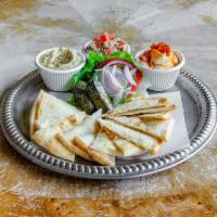 Mezza Platter · Toasted pita, hummus, garlic spread, quinoa tabbouleh, grape leaves, herbs, and spices. Vega...