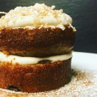 Carrot Cake · Made with raisins and pineapple, classic cream cheese frosting, and toasted coconut. Served ...