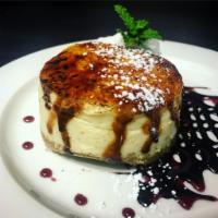 Bruleed Cheesecake · NY cheesecake, Brulee sugar top, and graham crust. Served with whipped cream.
