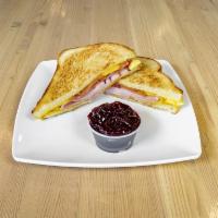 Elevate Breakfast Sandwich · Egg, ham, bacon, and cheese on grilled sourdough. Served with a jam for dipping.