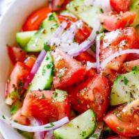 CUCUMBER SALAD · Sliced cucumber, tomatoes, and onions, topped with herbs and lemon juice as dressings  