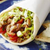 Chicken Shawarma Wrap · Thin slices of chicken thigh, served on warm pita bread with lettuce onions tomatoes and gar...