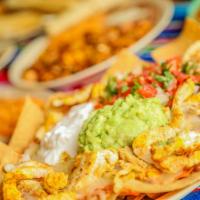 Nachos · Bean and cheese, guacamole and sour cream and chopped salsa. Add meat for an additional char...