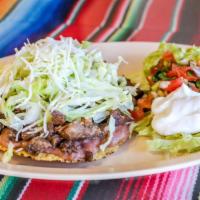 Tostada · Your choice of protein on a thin corn tostada with beans, lettuce, pico de gallo, and cheese