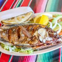 Mojarra Frita · Whole Tilapia fish deep fried down to perfection. Served with rice, beans, and tortillas!