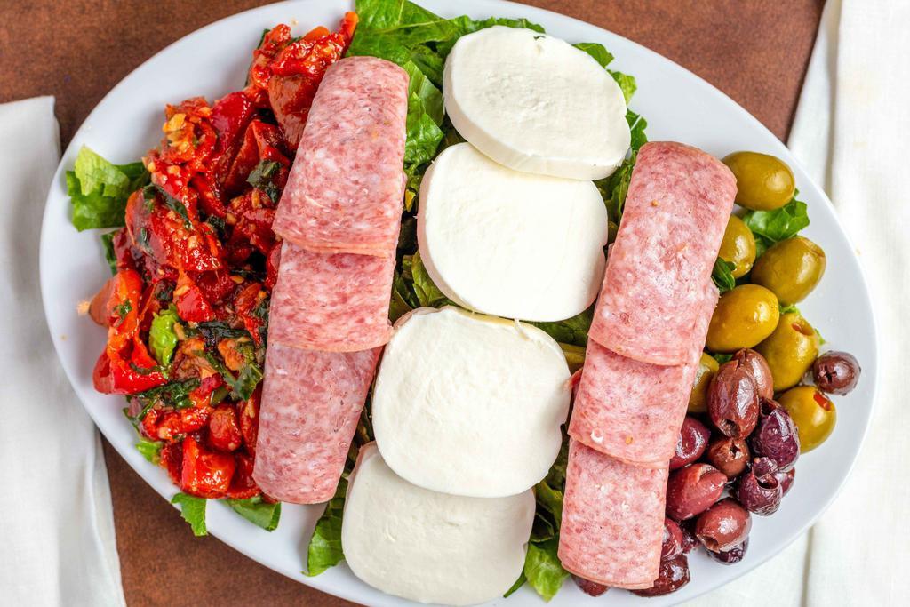 Antipasto Salad · Romaine lettuce topped with fresh mozzarella, genoa salami, kalamata olives, green olives and roasted red peppers tossed in our homemade Italian vinaigrette.