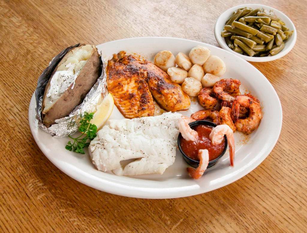 Broiled Seafood Platter Combo · A hand cut cod fillet, scallops, Cajun and cocktail shrimp and a Cajun grilled tilapia fillet.