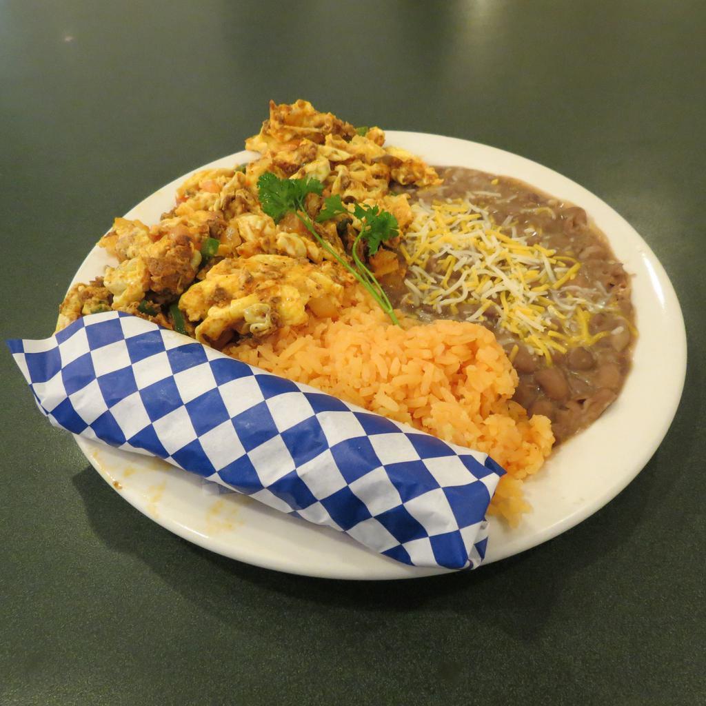Huevos Rancheros · Scrambled eggs with tomatoes, onions and jalapenos with refried beans with cheese and rice. Served with corn tortillas, salsa and sour cream on the side. Add chorizo sausage for an additional charge.