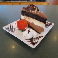 Sinful Seven Cake · Intense chocolate cake layered in juxtaposing strips of milk and white chocolate mousse. The...