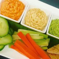 Hummus Trio · Traditional, roasted red pepper and basil hummus, grilled flatbread, carrots and celery.