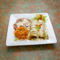 Enchiladas Suizas · 2 tortillas dipped in a tomatillo green sauce, stuffed with chunks of chicken rolled and top...