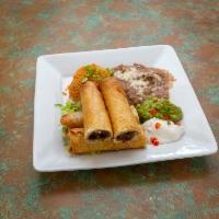Flautas de Toto · 2 flour tortillas rolled, 1 with beef and cheese, 1 chicken and cheese, deep fried, garnishe...