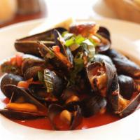 Steamed Mussels · Steamed mussels in a light, white wine marinara broth sauce.
