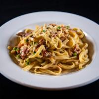 Fettuccini Carbonara · Ham and peas in a Parmesan cream sauce. Served with shaved Parmesan cheese.