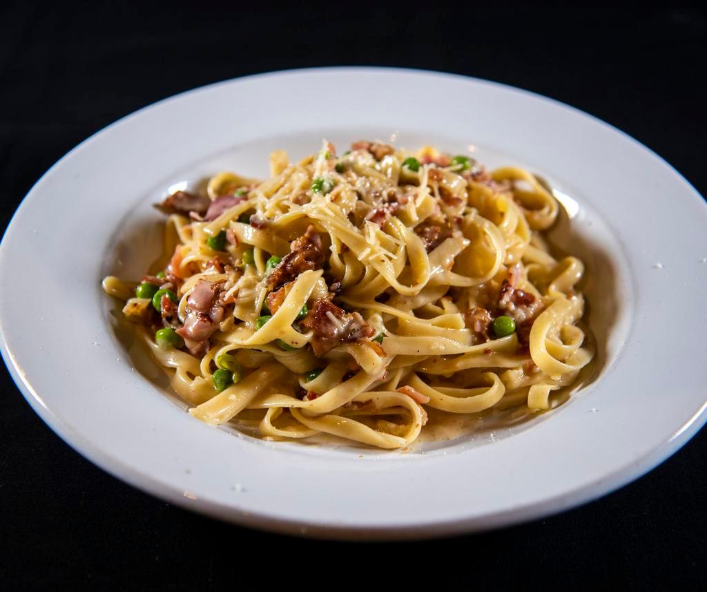 Fettuccini Carbonara · Ham and peas in a Parmesan cream sauce. Served with shaved Parmesan cheese.