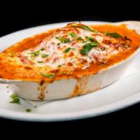 Lasagna · Bolognese (meat) or vegetarian. Served with shaved Parmesan cheese.