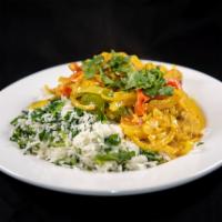Frango a Brasileira · Chicken sauteed in saffron dark beer sauce with peppers, onions, tomatoes, rice, and spinach.