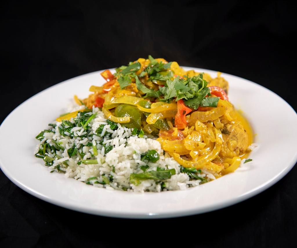 Frango a Brasileira · Chicken sauteed in saffron dark beer sauce with peppers, onions, tomatoes, rice, and spinach.