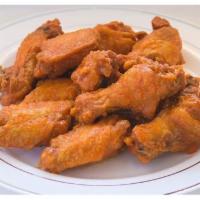 Traditional Wings · Cooked wings of a chicken coated in sauce or seasoning. 