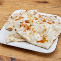 Honey Naan · Traditional Indian bread cooked in a clay tandoor oven with honey drizzled on top.