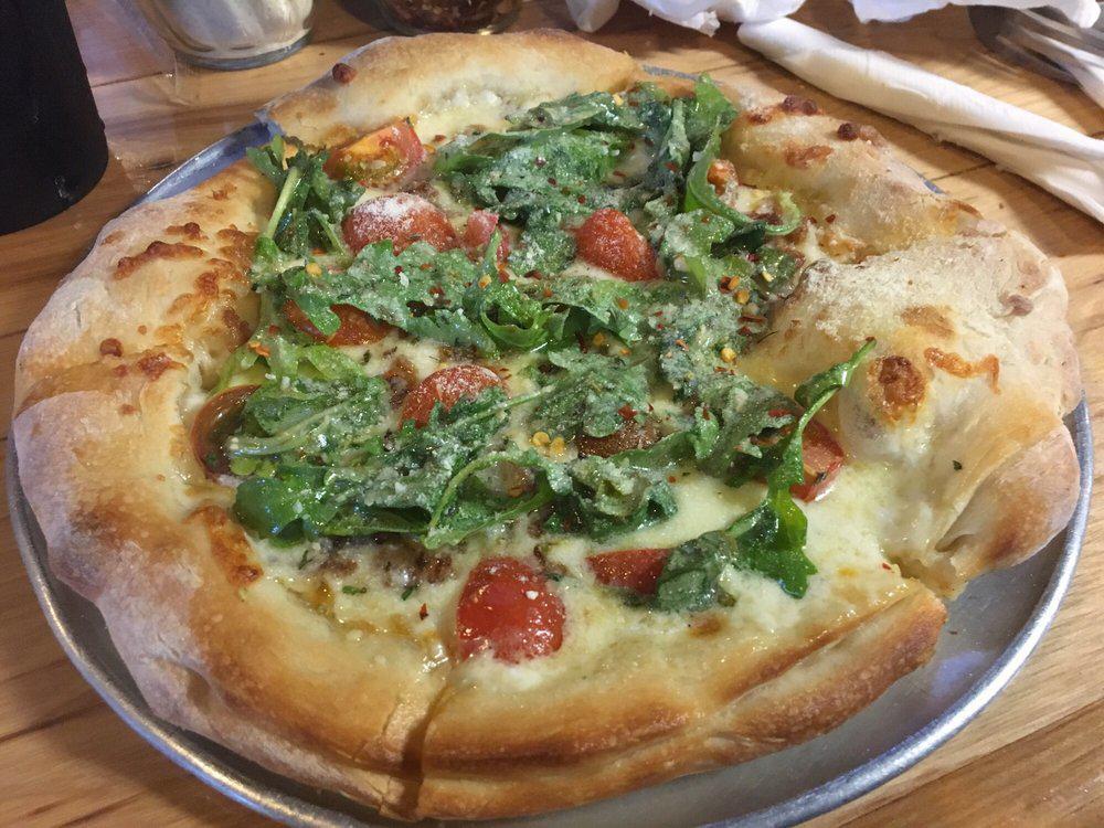 BLT Pizza · A lite pizza with bourbon bacon, heirloom tomatoes, baby arugula all on a 4 blend cheese and Alfredo sauce.