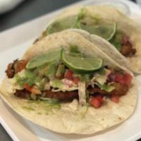 Shrimp Tacos · 2 soft flour or corn tortillas stuffed with marinated grilled (16/20) shrimp topped with our...