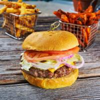 Queso Burger · 100% all-natural Angus beef cheeseburger. Topped with lettuce, tomato & our secret burger sa...