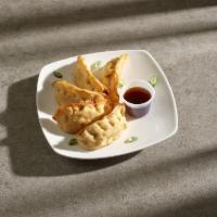 Gyoza · Five pieces. Pan fried pork gyoza served with special sauce. 
