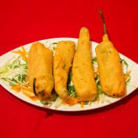 5. Hari Mirchi Bhajia · Fresh green chilis stuffed with a spicy potato mixture, dipped in batter, fried and served w...