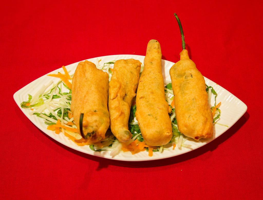 5. Hari Mirchi Bhajia · Fresh green chilis stuffed with a spicy potato mixture, dipped in batter, fried and served with chutney.