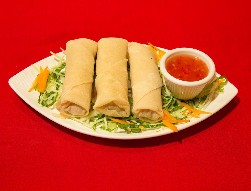 7. Spring Roll · Golden fried crispy rolls served with sweet chili sauce.