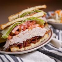 Turkey Club Sandwich   · Turkey, bacon, lettuce and tomato on toasted sourdough bread. Served with side. 