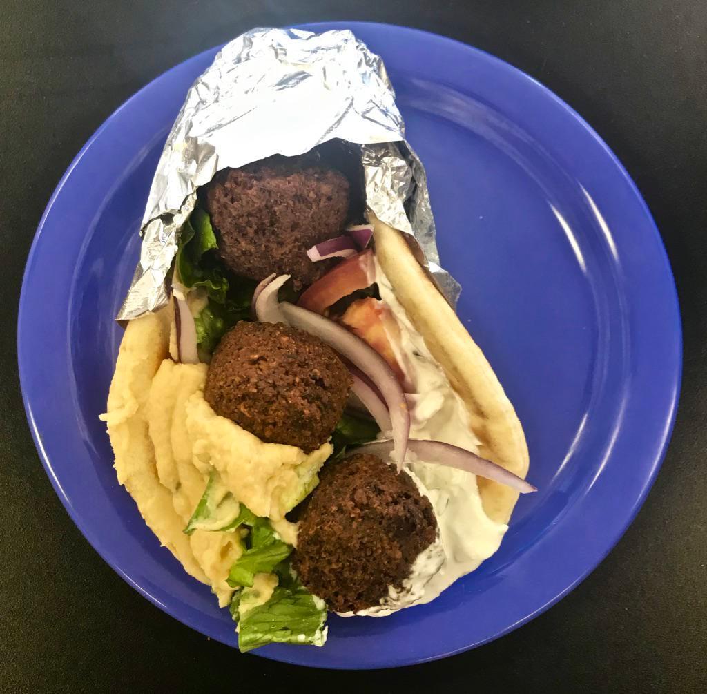 Falafel Pita · Homemade falafel on a Mediterranean pita with lettuce, tomato, red onion and cucumber. Served with your choice of tzatziki or hummus.

Note: Prices are 30% higher here than in store. Call us for pick up!