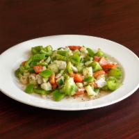 Fattoush Salad · Tomato, cucumber, onion, bell peppers, toasted pita bread, and spices tossed in olive oil an...