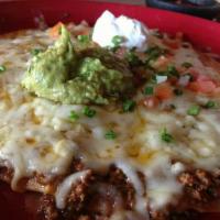 Mexican Pizza · Crisp flour tortilla topped with beans, Jack cheese, tomatoes and green onions. Garnished wi...