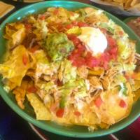 Nachos Supreme · Crisp tortilla chips loaded with chicken, ground beef, shredded beef, beans and cheese dip s...