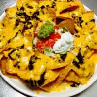 Nachos Cheese · Add chicken, ground beef, shredded beef or chorizo and guacamole or sour cream for an additi...