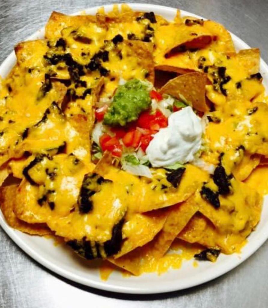 Nachos Cheese · Add chicken, ground beef, shredded beef or chorizo and guacamole or sour cream for an additional charge.