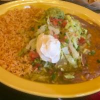 Enchiladas Deluxe · 2 flour tortillas filled with your choice of meat topped with green tomatillo sauce, Jack ch...