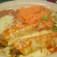 Enchiladas Cremadas · 2 corn tortillas filled with shredded chicken. Topped with delicious cream sauce and Monterr...